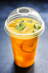 orange juice or lemonade with mint or lemonade with mint  transparent glass cup with mint takeaway drink Menu concept serving size food background top view copy space for text organic healthy eating