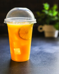 orange juice or lemonade with mint or lemonade with mint  transparent glass cup with mint takeaway drink Menu concept serving size food background top view copy space for text organic healthy eating