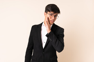 Businessman over isolated beige background whispering something