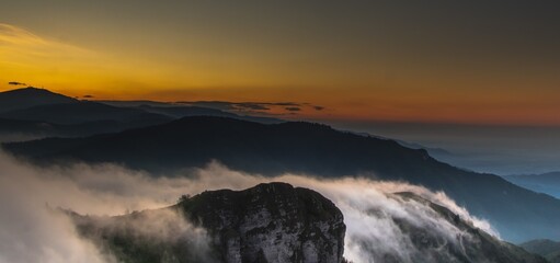 Mountain and soft clouds during a colorful dawn