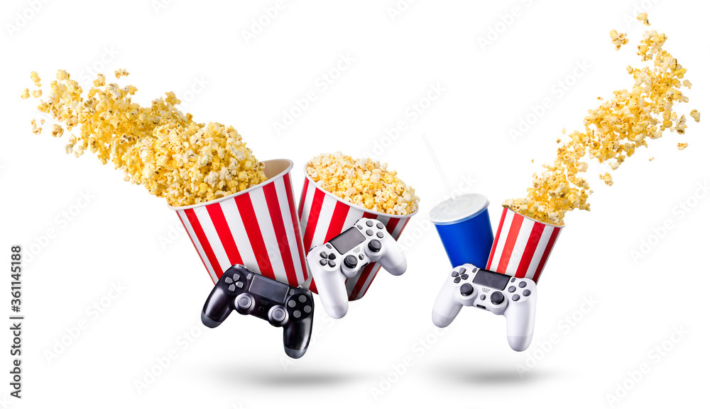 Wall mural Paper bucket with popcorn, cup of drink and video game joystick on white