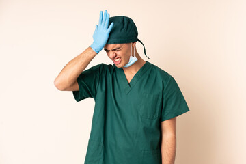 Surgeon man in blue uniform over isolated background having doubts with confuse face expression