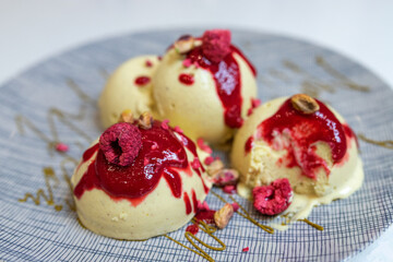 Pistachio ice cream balls with raspberry and berry sauce