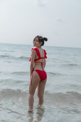 Young sexy woman in bikini enjoying summer vacation on beach relaxing holiday