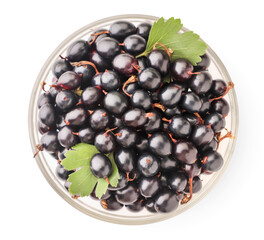 Black currants in a bowl on a white background. The view from top