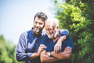 Foto op Plexiglas Adult hipster son and old senior father stay for work at home, two generations have a beard talking together and relaxing with smile, happy enjoy living to isolation quarantine at home, father's day © chokniti