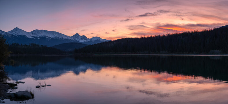 Patricia lake with mountain range reflection colorful sky at sunset at Jasper national park