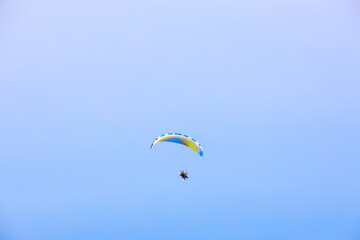 PATTAYA/CHONBURI/THAILAND - JUNE 13 2020: Man flying paramotor in the sky, Extreme sport paramotor flying.