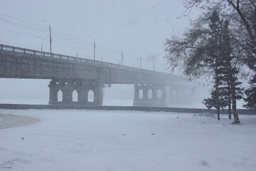 Walk along the winter embankment in a Snowfall.