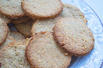 Composition of homemade macaroons on a craft clay plate, on a light background