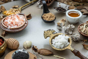 Various spices and herbs in rustic style with honey on balck background. Natural herbs medicine, Organic herbal and healthy concept, Selective focus.
