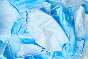 Used blue protective surgical masks. Covid-19, SARS-CoV-2 consequences. Medical trash. 