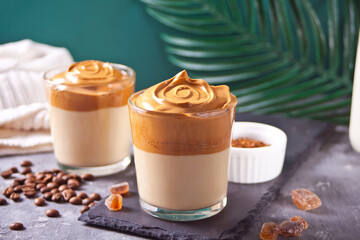 Dalgona Coffee. Fluffy creamy whipped coffee on the concrete background. Trendy beverage.