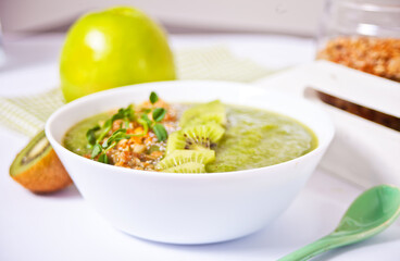 Fresh blended green smoothie bowl with muesli and chia seeds. Health and detox concept.