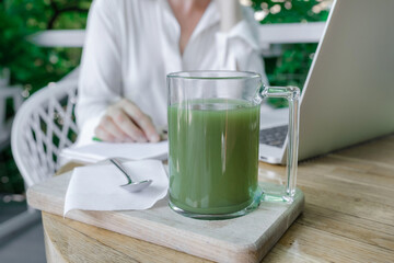 woman cup green matcha latte coffee tea glass work place cafe terassa home freelancer