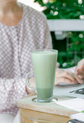 woman cup green matcha latte coffee tea glass work place cafe terassa home freelancer