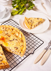 Homemade freshly tasty French quiche Lorraine tart pie with chicken meat and mushrooms.