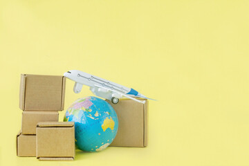 Airplane and stack of cardboard boxes. concept of air cargo and parcels, airmail. Fast delivery of goods and products. Cargo aircraft. Logistics, connection to hard-to-reach places. Banner, copy space