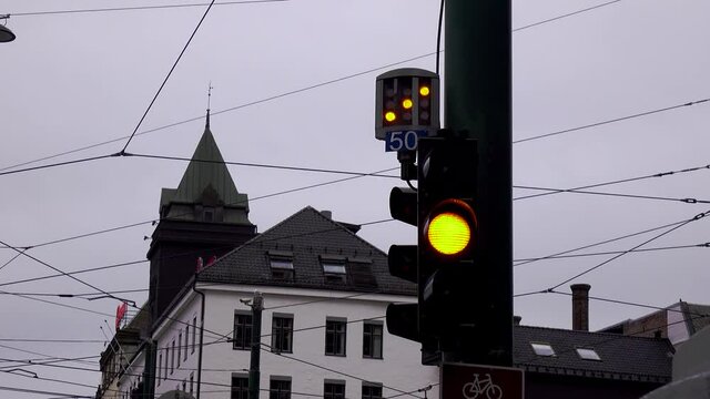traffic light surrounded by wires turns red in a northern Europe town, close up