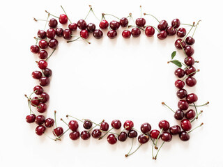 Frame of large ripe cherry berries on white background. Natural summer food background. Creative food summer layout. top view. Copy space