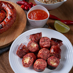 .Grilled Brazilian sausage stuffed with cheese on a wooden board. Brazilian barbecue.. Selective focus