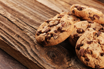 Chocolate cookies on wooden table. Chocolate chip cookies shot on vintage background