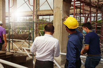 Naklejka na ściany i meble Supervisor and engineers are checking the correctness of building construction.
