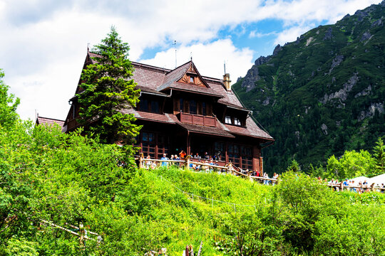 MORSKIE OKO, POLAND - JULY 6, 2019: Mountain shelter house in Tatra Mountains, Morskie Oko Lake, Poland. Tatra Mountains is very popular travel destination.