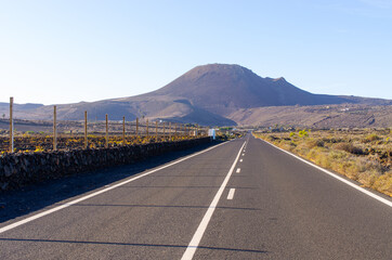 Naklejka premium Black road on volcanic island, Lanzarote, Spain