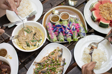 people enjoy eating thai food together, top view