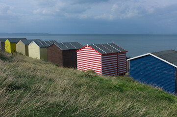 Naklejka premium Traditional colorful English beach huts in Whitstable, Kent in the United Kingdom