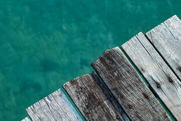 old wood plank of jetty against blue sea