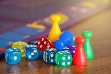 colorful dices with board game component in background