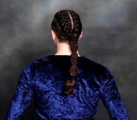 Attractive male model with braids posing in studio. Avantgarde, style, fashion concept.