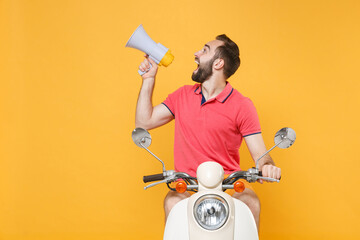Excited young bearded man guy in casual summer clothes driving moped isolated on yellow wall background studio portrait. Driving motorbike transportation concept. Scream in megaphone, looking aside.