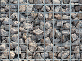 a lot of stones under a metal net
