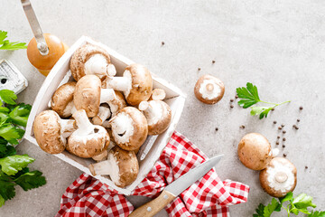 Raw mushrooms champignons on white background, cooking fresh champignons