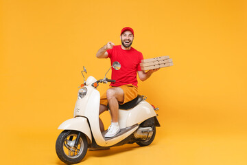 Delivery man in red cap t-shirt uniform driving moped motorbike scooter hold pizza in cardboard...