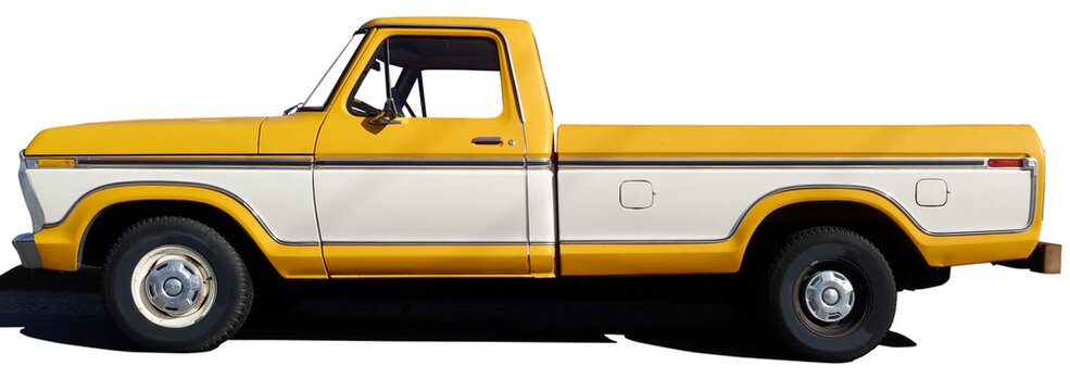 Side view of classic vintage yellow pickup truck with wide side accent.