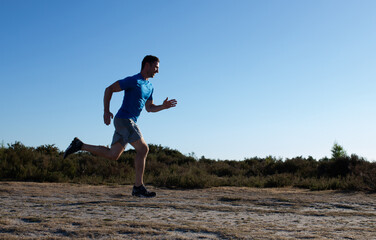 man sprinting in the countryside