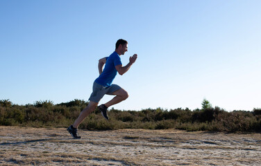 man sprinting in the countryside