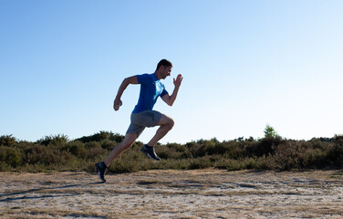 man sprinting in the countryside
