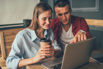 Man and woman testing software on laptop