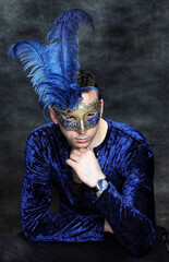 Attractive male model with braids posing in studio. Avantgarde, style, fashion concept.