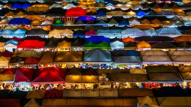 time lapse Top view of Train Night Market Ratchada (Talad Rot Fai). market with plenty of shops with colorful canvas roofs at night in Bangkok, Thailand