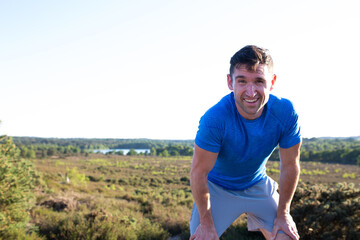 Man leaning on knees smiling to camera