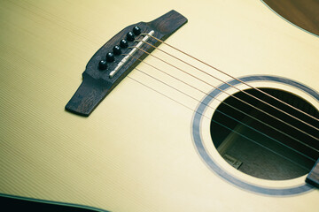 Close up of acoustic guitar with metal strings. Music concept