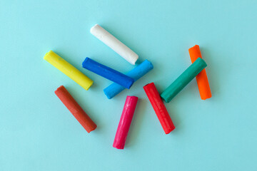 Multi-colored children's plasticine on a blue background. Craft with kids. Art tools. 