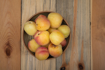 Fresh Apricot in bown in kitchen table top view.