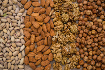 Collected mix nuts: almonds, pistachios, walnuts, hazelnuts. Assorted nuts background